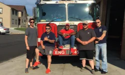 Five volunteers with Parkside in front of a firetruck